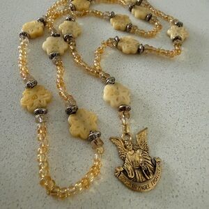 Elegant Gold and Cream Necklace with Guardian Angel Pendant